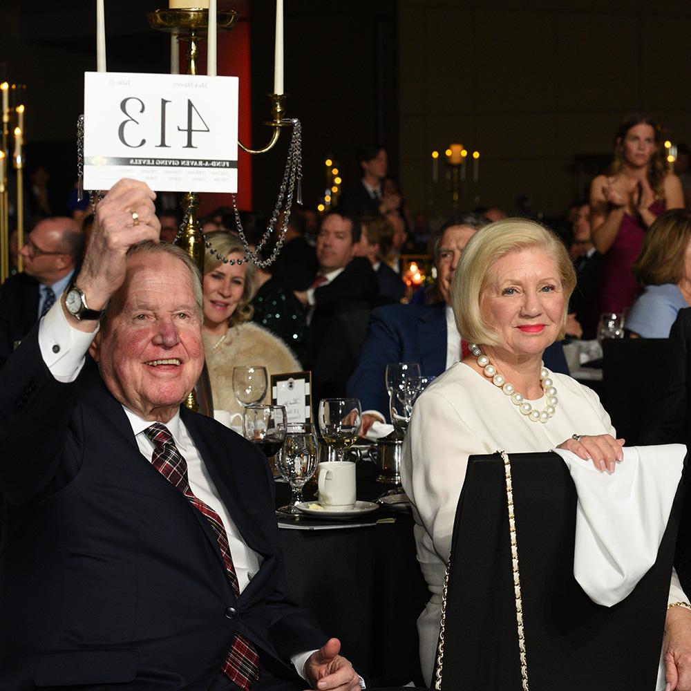 A donor raises his bid card during the Scholarship Ball